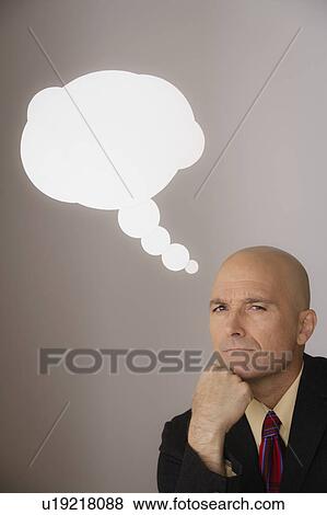 Studio shot of pensive business man with speech bubble above head View Large Photo Image Stock Photo - Studio shot of pensive business man with speech bubble above head. Fotosearch