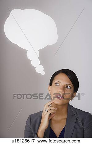 Studio shot of pensive business woman with speech bubble above head View Large Photo Image Stock Photo - Studio shot of pensive business woman with speech bubble above head. Fotosearch