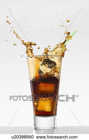 Stock Image - Studio shot of soda with splash. Fotosearch