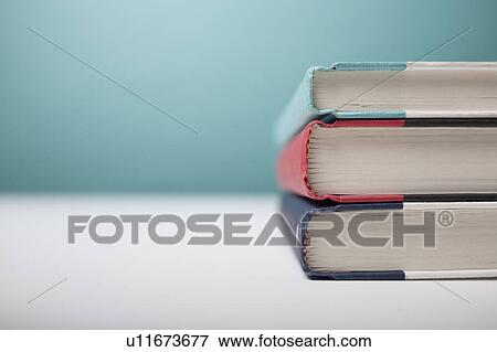 Studio shot of three books in stack View Large Photo Image Stock Photo - Studio shot of three books in stack. Fotosearch
