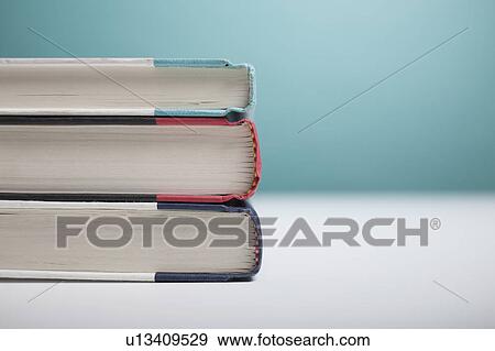 Stock Photo - Studio shot of three books in stack. Fotosearch