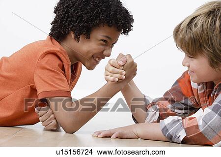 Picture - Studio shot of two boys (8-9) arm-wrestling. Fotosearch