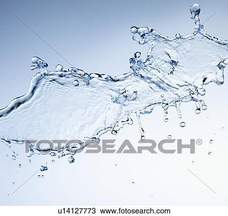 Stock Image - Studio shot of water splash on blue background. Fotosearch