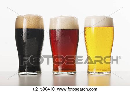 Stock Image - Three beers in glasses, studio shot. Fotosearch