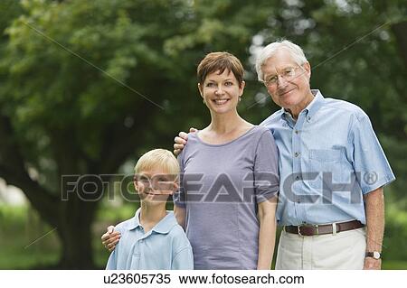 Stock Photography - Three generation family standing in park. Fotosearch