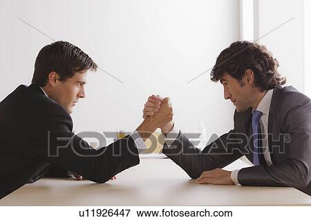Stock Photo - Two business men armwrestling. Fotosearch