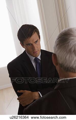 Picture - Two business men discussing in office. Fotosearch