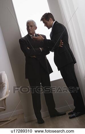 Stock Image - Two business men discussing in office. Fotosearch