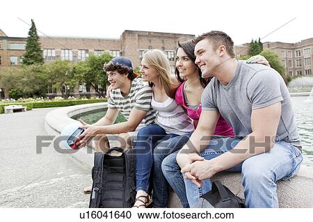 Two couples sitting at fountain View Large Photo Image Stock Image - Two couples sitting at fountain. Fotosearch