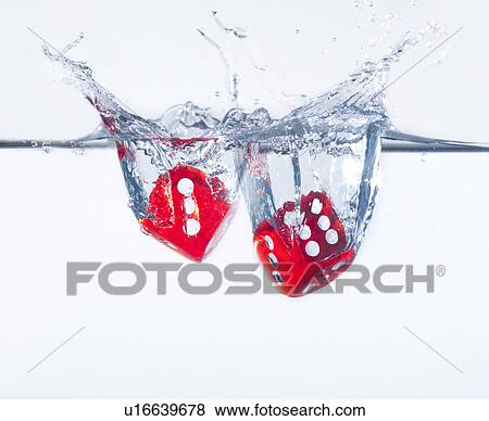 Stock Photo - Two dices splashing into water, studio shot. Fotosearch
