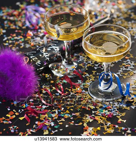 Two glasses of champagne and confetti View Large Photo Image Stock Image - Two glasses of champagne and confetti. Fotosearch