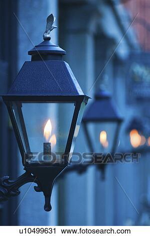 Stock Image - USA, Georgia, Savannah, Close up of gas street lamps at dusk. Fotosearch