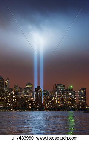 Stock Image - USA, New York, New York City, Cityscape at night with tribute in light. Fotosearch