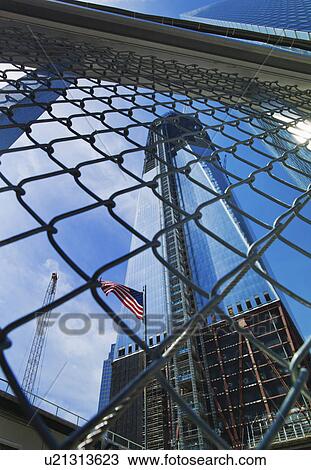 USA, New York, New York City, Lower Manhattan, Ground Zero, Freedom Tower seen through chainlink fence View Large Photo Image Stock Image - USA, New York, New York City, Lower Manhattan, Ground Zero, Freedom Tower seen through chainlink fence. Fotosearch