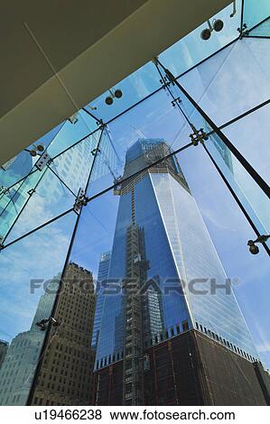 Stock Photo - USA, New York, New York City, Lower Manhattan, Ground Zero, reflection of Freedom Tower in glass wall. Fotosearch