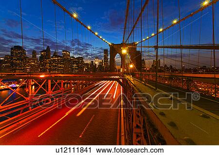 Stock Image - USA, New York State, New York City, Brooklyn Bridge at dusk. Fotosearch