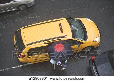 USA, New York State, New York City, Manhattan, People getting into taxi cab View Large Photo Image Stock Image - USA, New York State, New York City, Manhattan, People getting into taxi cab . Fotosearch