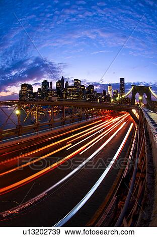Stock Photo - USA, New York State, New York City, Manhattan, Brooklyn Bridge at dusk. Fotosearch