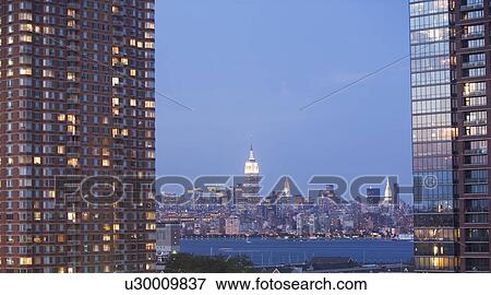 Stock Photo - USA, New York State, New York City, Manhattan, Skyscrapers of Manhattan at dusk. Fotosearch