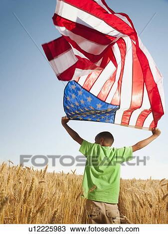 USA, Oregon, Wasco, Boy (8-9) flying american flag in wheat field with wind turbines in background View Large Photo Image Stock Image - USA, Oregon, Wasco, Boy (8-9) flying american flag in wheat field with wind turbines in background. Fotosearch