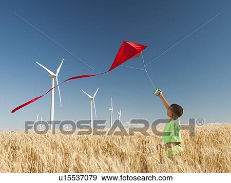 USA, Oregon, Wasco, Boy (8-9) playing with kite in wheat field, wind turbines in background View Large Photo Image Stock Photo - USA, Oregon, Wasco, Boy (8-9) playing with kite in wheat field, wind turbines in background. Fotosearch
