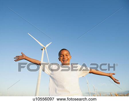 USA, Oregon, Wasco, Boy (8-9) standing in front wind turbine View Large Photo Image Stock Photo - USA, Oregon, Wasco, Boy (8-9) standing in front wind turbine. Fotosearch