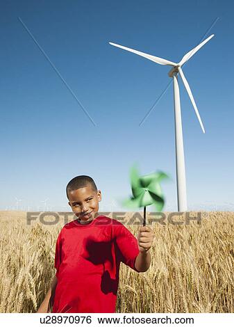 USA, Oregon, Wasco, Girl (10-11) holding fan in wheat field with wind turbines in background View Large Photo Image Stock Photograph - USA, Oregon, Wasco, Girl (10-11) holding fan in wheat field with wind turbines in background. Fotosearch