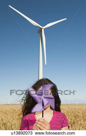 USA, Oregon, Wasco, Girl (12-13) holding fan n front of wind turbines View Large Photo Image Stock Image - USA, Oregon, Wasco, Girl (12-13) holding fan n front of wind turbines. Fotosearch