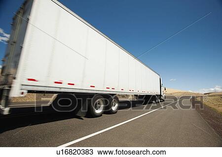 Stock Image - USA, Oregon, Wasco, Lorry travelling through rural landscape. Fotosearch