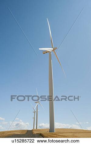 USA, Oregon, Wasco, Wind turbines along dirt road between wheat fields View Large Photo Image Stock Image - USA, Oregon, Wasco, Wind turbines along dirt road between wheat fields. Fotosearch