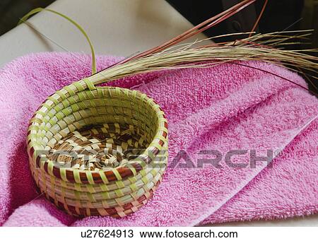 Stock Image - USA, South Carolina, Charleston, Close up of sweetgrass basket on towel. Fotosearch