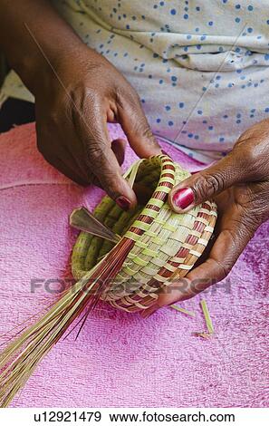 USA, South Carolina, Charleston, Close up of woman's hand weaving sweetgrass basket View Large Photo Image Stock Photo - USA, South Carolina, Charleston, Close up of woman's hand weaving sweetgrass basket. Fotosearch