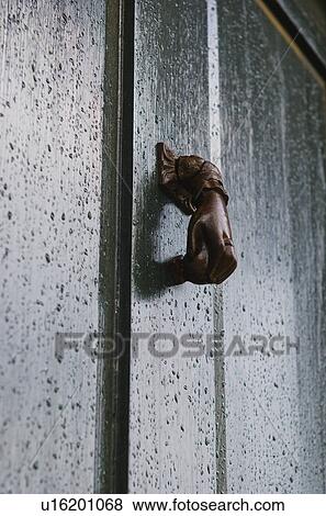Stock Photo - USA, South Carolina, Charleston, Close up of door knocker on door in rain. Fotosearch
