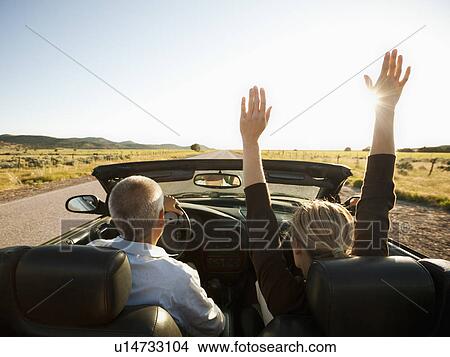 USA, Utah, Kanosh, Mad-adult couple driving through desert plains in convertible car View Large Photo Image Picture - USA, Utah, Kanosh, Mad-adult couple driving through desert plains in convertible car. Fotosearch