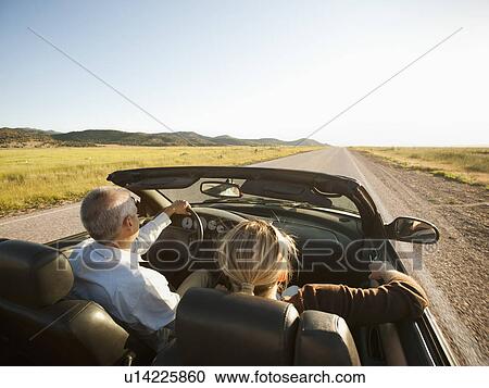 USA, Utah, Kanosh, Mad-adult couple driving through desert plains in convertible car View Large Photo Image Stock Image - USA, Utah, Kanosh, Mad-adult couple driving through desert plains in convertible car. Fotosearch