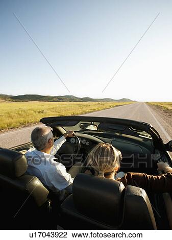 USA, Utah, Kanosh, Mad-adult couple driving through desert plains in convertible car View Large Photo Image Stock Image - USA, Utah, Kanosh, Mad-adult couple driving through desert plains in convertible car. Fotosearch