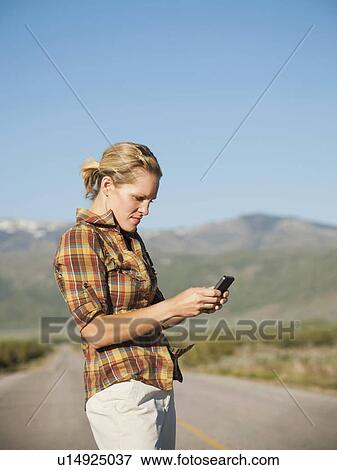 USA, Utah, Kanosh, Mid adult woman calling emergency services on empty desert road View Large Photo Image Stock Photo - USA, Utah, Kanosh, Mid adult woman calling emergency services on empty desert road. Fotosearch