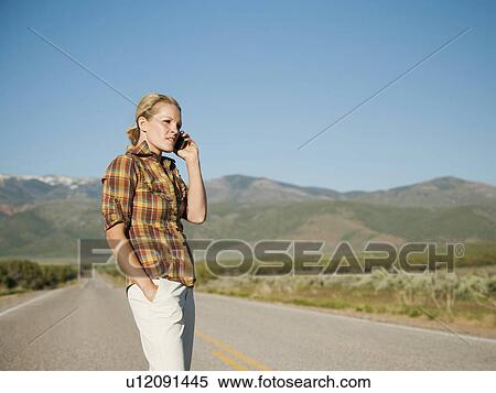 USA, Utah, Kanosh, Mid adult woman calling emergency services on empty desert road View Large Photo Image Stock Photography - USA, Utah, Kanosh, Mid adult woman calling emergency services on empty desert road. Fotosearch