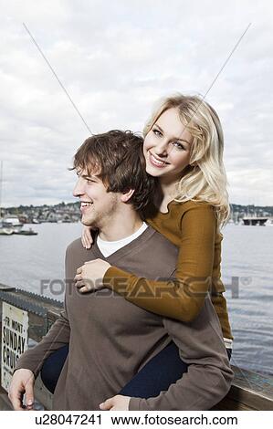 USA, Washington, Seattle, Young couple on pier, woman looking at camera View Large Photo Image Stock Image - USA, Washington, Seattle, Young couple on pier, woman looking at camera. Fotosearch