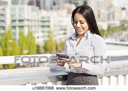USA, Washington, Seattle, Young businesswoman text-messaging View Large Photo Image Stock Photo - USA, Washington, Seattle, Young businesswoman text-messaging. Fotosearch