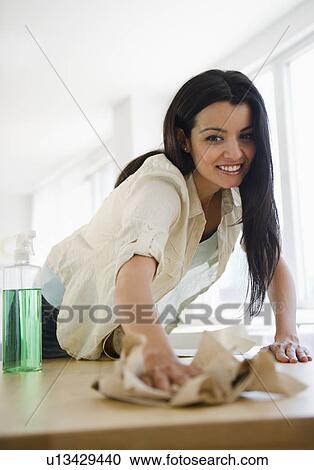 Woman cleaning table View Large Photo Image Stock Image - Woman cleaning table. Fotosearch