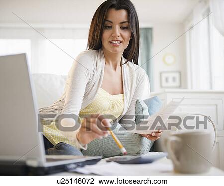Woman doing paperwork at home View Large Photo Image Stock Image - Woman doing paperwork at home. Fotosearch