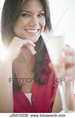 Stock Image - Woman drinking champagne. Fotosearch