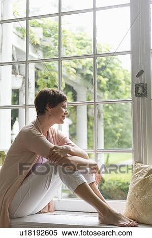 Woman looking through window View Large Photo Image Stock Photography - Woman looking through window. Fotosearch