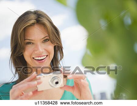 Woman photographing with digital camera View Large Photo Image Stock Photo - Woman photographing with digital camera. Fotosearch