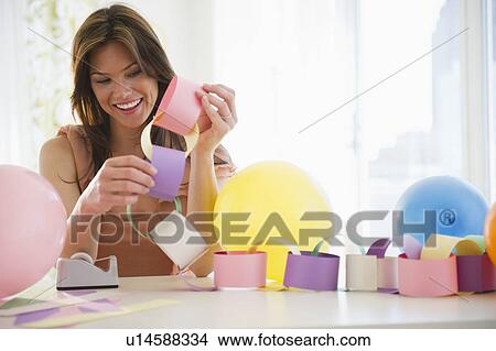 Woman preparing paper chain View Large Photo Image Picture - Woman preparing paper chain. Fotosearch