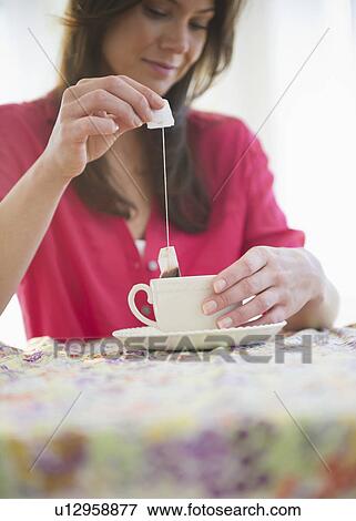 Stock Photo - Woman preparing tea. Fotosearch