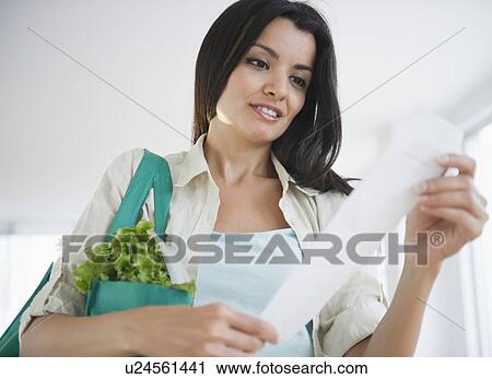 Woman reading receipt View Large Photo Image Stock Image - Woman reading receipt. Fotosearch