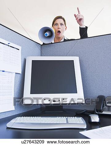 Woman shouting through megaphone in office cubicle View Large Photo Image Stock Photo - Woman shouting through megaphone in office cubicle. Fotosearch