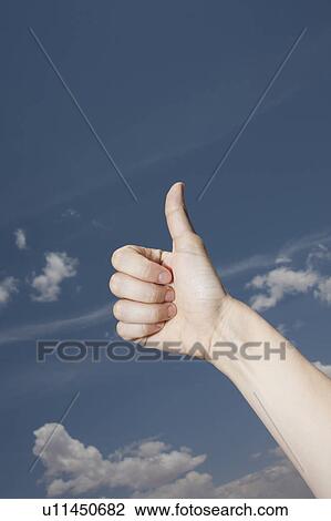 Woman's hand showing thumbs-up gesture against sky View Large Photo Image Stock Image - Woman's hand showing thumbs-up gesture against sky. Fotosearch
